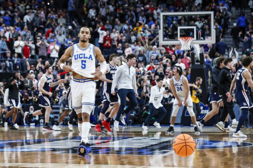 Las Vegas, NV, Thursday, March 23, 2023 - UCLA Bruins guard Amari Bailey (5) walks away from the Gonzaga Bulldogs who are celebrating a 79-76 win in a Sweet 16 game at the NCAA Men's Division 1 Basketball Tournament at T-Mobile Arena. (Robert Gauthier/Los Angeles Times)