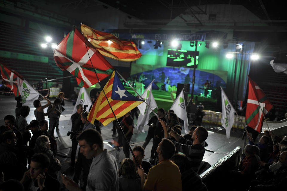 Supporters of Euskal Herria Bildu, the new pro independence Basque Party, wave Basque flags and Catalunya flags, after parliamentary elections to the next Basque Parliament, in Bilbao, northern Spain, Sunday Oct. 21, 2012. Almost 4.5 million people will go to the polls Sunday in regional elections in Spain's turbulent Basque region and in northwestern Galicia.(AP Photo/Alvaro Barrientos)