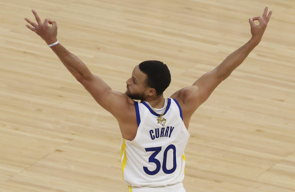 Golden State Warriors guard Stephen Curry (30) reacts after teammate guard Klay Thompson (11) makes a three point basket against the Boston Celtics in the NBA Finals