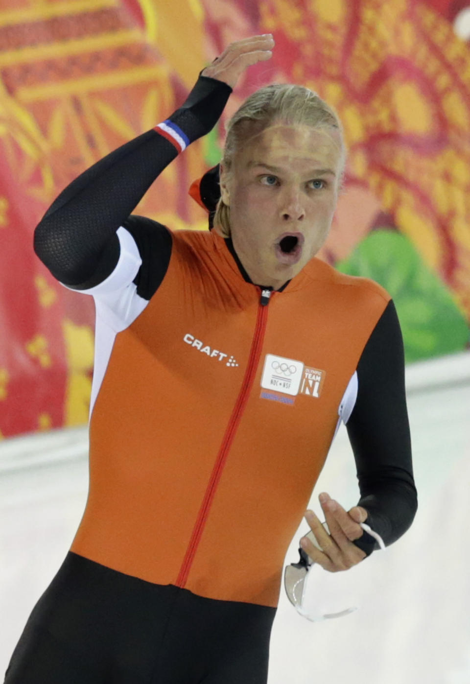 Silver medallist Koen Verweij of the Netherlands raises his hand when the race was declared a tie with gold medallist Poland's Zbigniew Brodka in the men's 1,500-meter speedskating race at the Adler Arena Skating Center during the 2014 Winter Olympics in Sochi, Russia, Saturday, Feb. 15, 2014. Verweij later was later declared silver, losing by three thousandth of a second. (AP Photo/Matt Dunham)