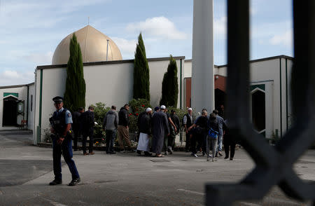 A policeman stands guard as members of the Muslim community visit Al-Noor mosque after it was reopened in Christchurch, New Zealand, March 23, 2019. REUTERS/Edgar Su