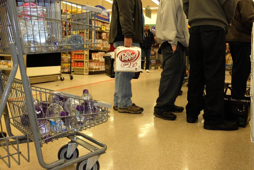 Residents of South Charleston, W.Va., wait in line at Kroger to buy water following a chemical spill on the Elk River that compromised the public water supply of eight counties on Thursday, Jan. 9, 2014. (AP Photo/Tyler Evert)