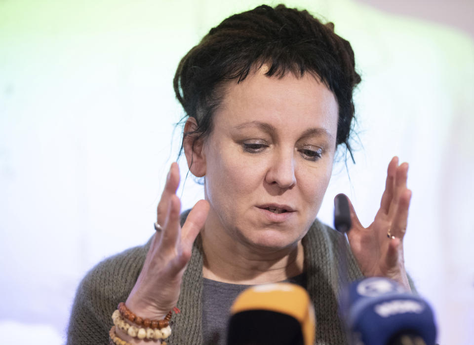 Polish author Olga Tokarczuk gestures during a press conference in Bielefeld, Germany, Thursday, Oct 10, 2019. Tokarczuk has been named recipient of the 2018 Nobel Prize in Literature, Thursday. Two Nobel Prizes in literature were announced Thursday after the 2018 literature award was postponed following sex abuse allegations that rocked the Swedish Academy at that time. (Friso Gentsch/dpa via AP)