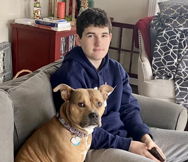 Jack Mulhall with his dog Peaches. Jack attended eighth grade with the online Stride program, but returned to a traditional high school for ninth grade in Loudoun County, Virginia, last fall. (Kate O’Harra)