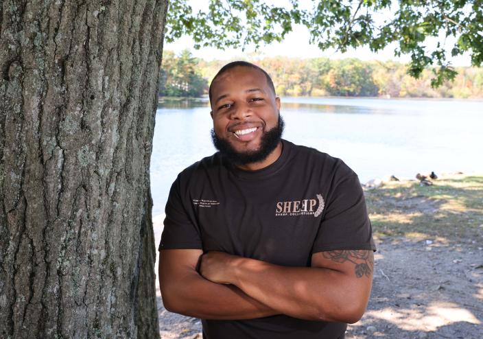 Max Del of Raldolph, owner of Sheep Collections, models one of the clothes line's T-shirts at D.W. Field Park in Brockton on Friday, Oct. 7, 2022.