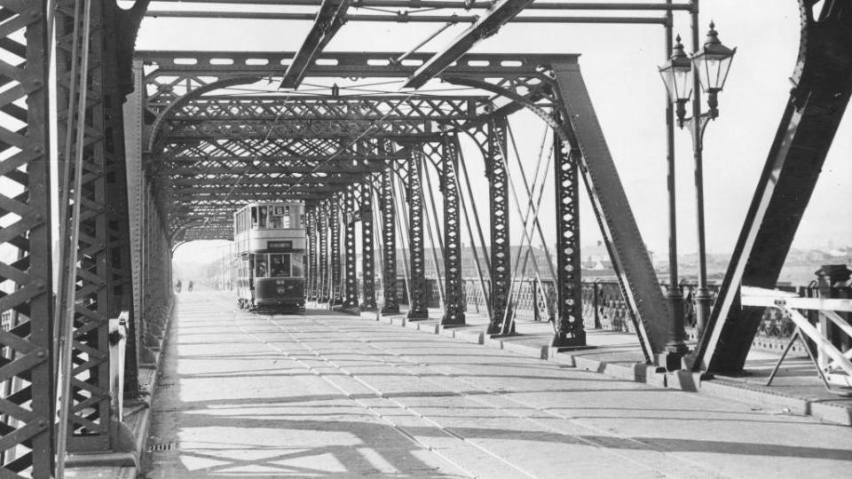 A tram crossing a swing bridge over the River Taff in Cardiff, circa 1940