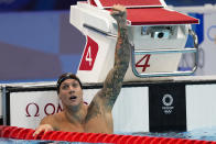 Caeleb Dressel, of United States, celebrates wining the gold medal in the men's 100-meter butterfly final at the 2020 Summer Olympics, Saturday, July 31, 2021, in Tokyo, Japan. (AP Photo/Jae C. Hong)