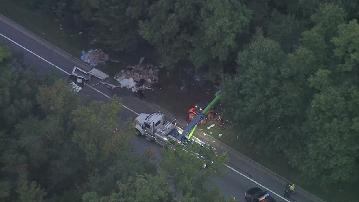 <div>Overturned tractor-trailer scatters debris along BW Parkway</div>