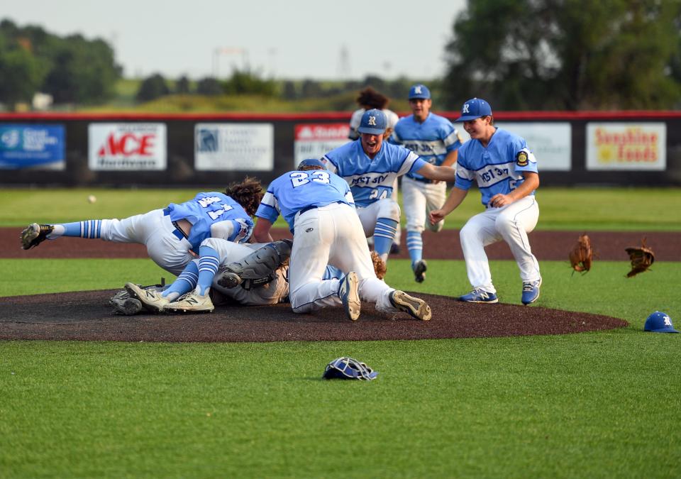 Renner players pile onto the pitcher after winning in the American Legion state baseball championship on Tuesday, July 27, 2021 at Aspen Park in Brandon.