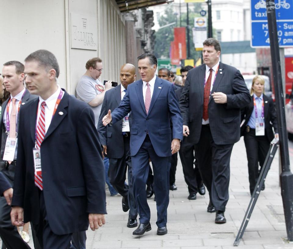 Avoiding a traffic jam, Republican presidential candidate, former Massachusetts Gov. Mitt Romney walks down Grosvenor Place in London to meet Ireland's Prime Minister Enda Kenny at the Embassy of Ireland in London, Friday, July 27, 2012. (AP Photo/Charles Dharapak)