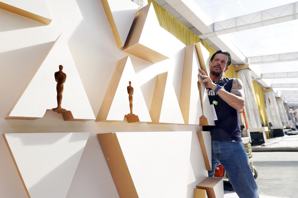 Local 33 head carpenter Gregg Strouth moves a wall into place outside the Dolby Theatre, Wednesday, March 23, 2022, in Los Angeles, in preparation for Sunday's 94th Academy Awards. (AP Photo/Chris Pizzello)