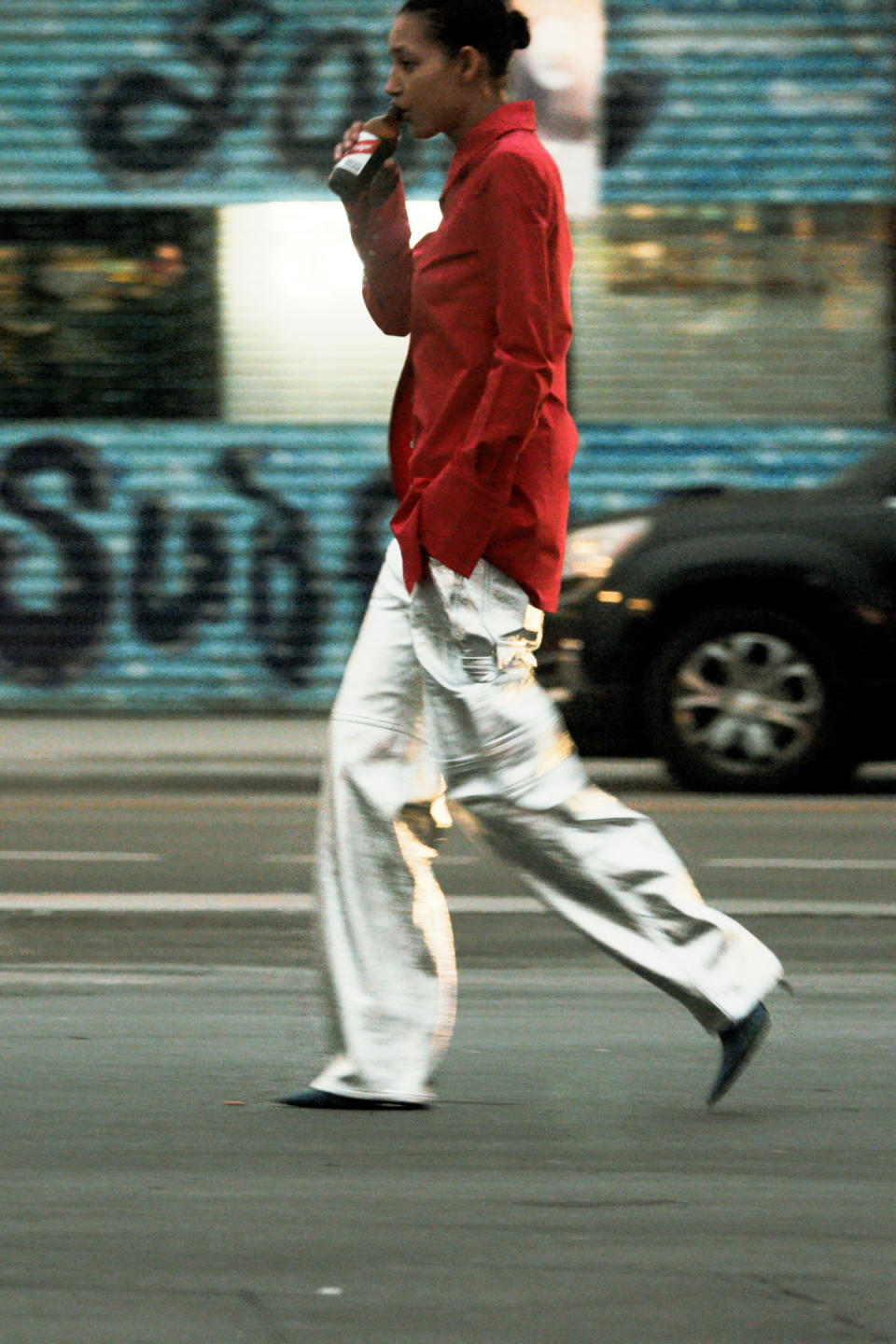 A model wearing silver chrome trousers and a red utility jacket from Interior Resort 2024.