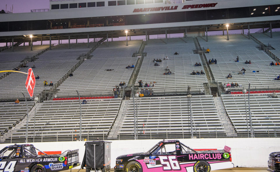 Some of the 1,000 fans allowed in for the NASCAR Truck Series auto race sit in the stands at Martinsville Speedway in Martinsville, Va., Friday, Oct. 30, 2020. (AP Photo Lee Luther Jr.)