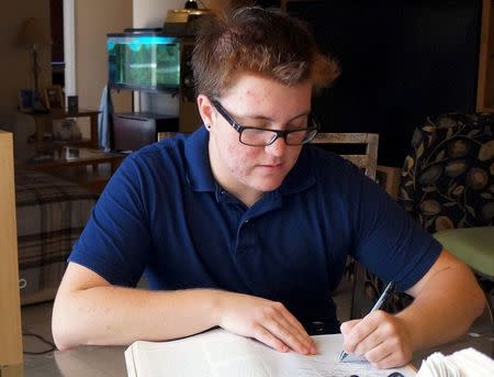 Nate Quinn, 17, works on a paper at his home in Sarasota, Florida, U.S., April 12, 2016. REUTERS/Letitia Stein