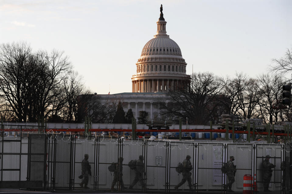 National Guards deploy inside the security perimeter surrounding the Capitol ahead of President-elect Joe Biden's inauguration ceremony, Tuesday, Jan. 19, 2021, in Washington. (AP Photo/Rebecca Blackwell)