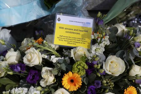 Floral tributes are seen outside New Scotland Yard, following the attack in Westminster earlier in the week, in London, Britain March 25, 2017. REUTERS/Peter Nicholls