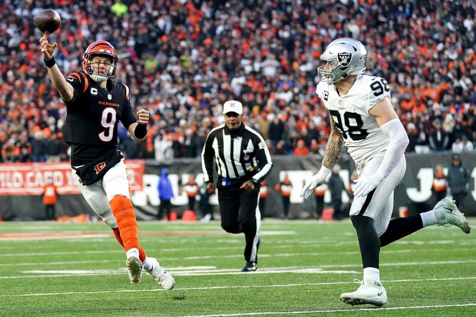 Cincinnati Bengals quarterback Joe Burrow throws as Las Vegas Raiders defensive end Maxx Crosby pressures in the second quarter during an NFL AFC wild-card playoff game.