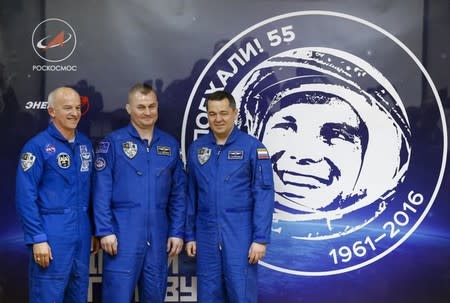 Members of the International Space Station (ISS) crew (L to R) Jeff Williams of the U.S., Alexey Ovchinin and Oleg Skriprochka of Russia pose after a news conference behind a glass wall at the Baikonur cosmodrome, Kazakhstan, March 17, 2016, ahead of their launch scheduled on March 19. REUTERS/Shamil Zhumatov