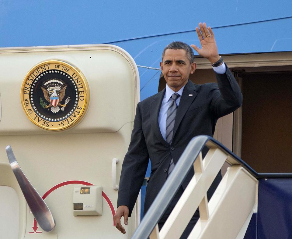 President Barack Obama waves as he gets off Air Force One upon his arrival at King Khalid International airport in Riyadh, Saudi Arabia, Friday, March 28, 2014. President Barack Obama is in Saudi Arabia to reassure the key Gulf ally that his commitment to the Arab world isn't wavering. (AP Photo/Pablo Martinez Monsivais)