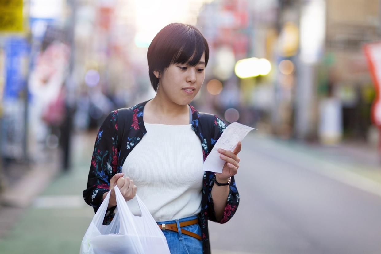 Woman checking her receipt