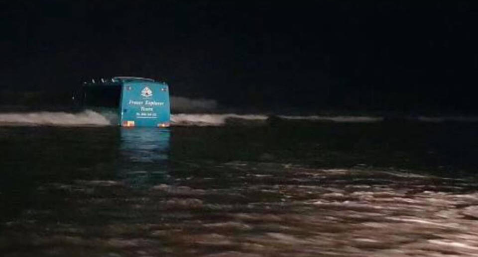 The bus also became stuck and had to spend the night in the ocean. Source: Facebook / Phillip Neumann and Ian Lassey via 7News