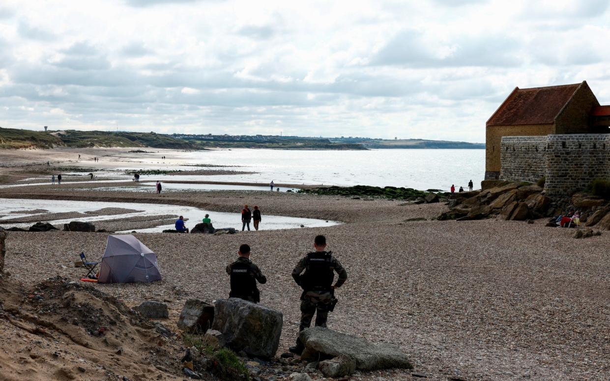 Gendarmes patrol the beach at Ambleteuse, where eight people died in a failed attempt to cross the Channel