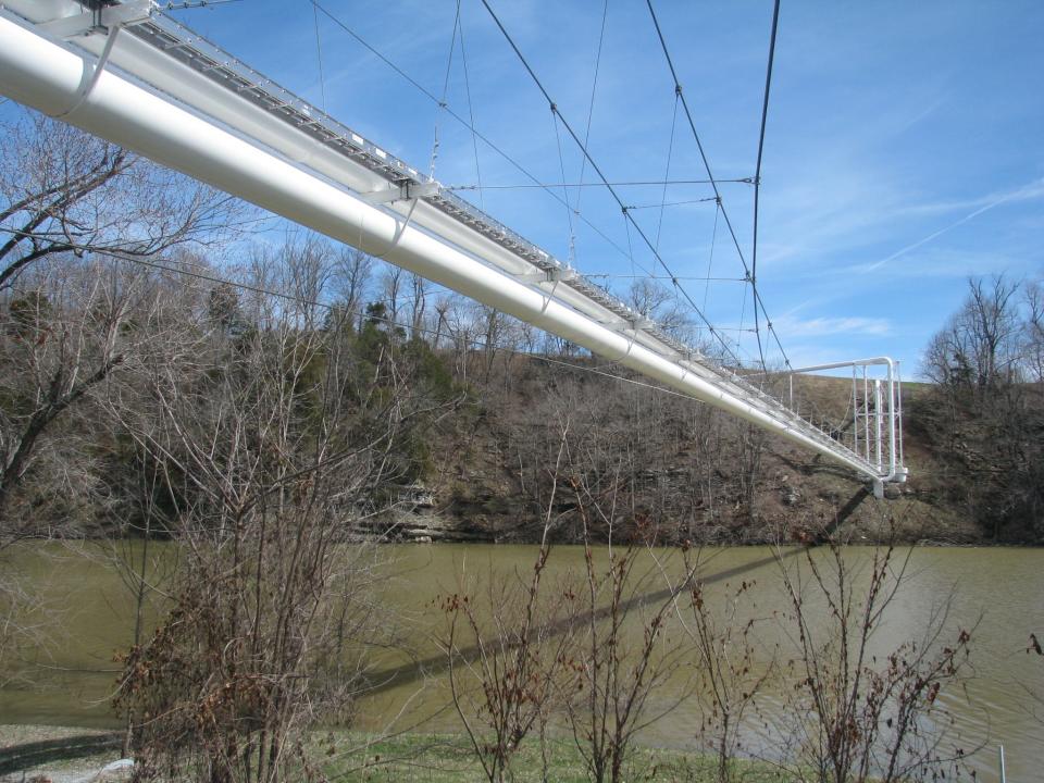 The Tennessee Gas Pipeline is suspended over the Dix River and Herrington Lake between Garrard and Boyle counties. The line, most of which is underground, was completed in 1944 as a part of a wartime effort to supply natural gas to the Northeast. Under a proposal, the line would be converted to transport natural gas liquids, and the flow would be reversed to move product from the Northeast. The proposal would also bury this segment of line in the rock beneath the lake. The lake level was higher than normal in this photo because of recent rains. Photo taken from the Boyle County side looking toward Garrard County on Monday, March 16, 2015. (AP Photo/Lexington Herald-Leader, Greg Kocher)