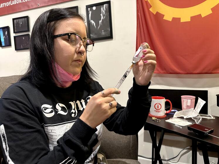 June Voros prepares insulin for her pump, which is then attached to her abdomen and delivers a steady stream of insulin to her body. (Angela Hart/KFF Health News)