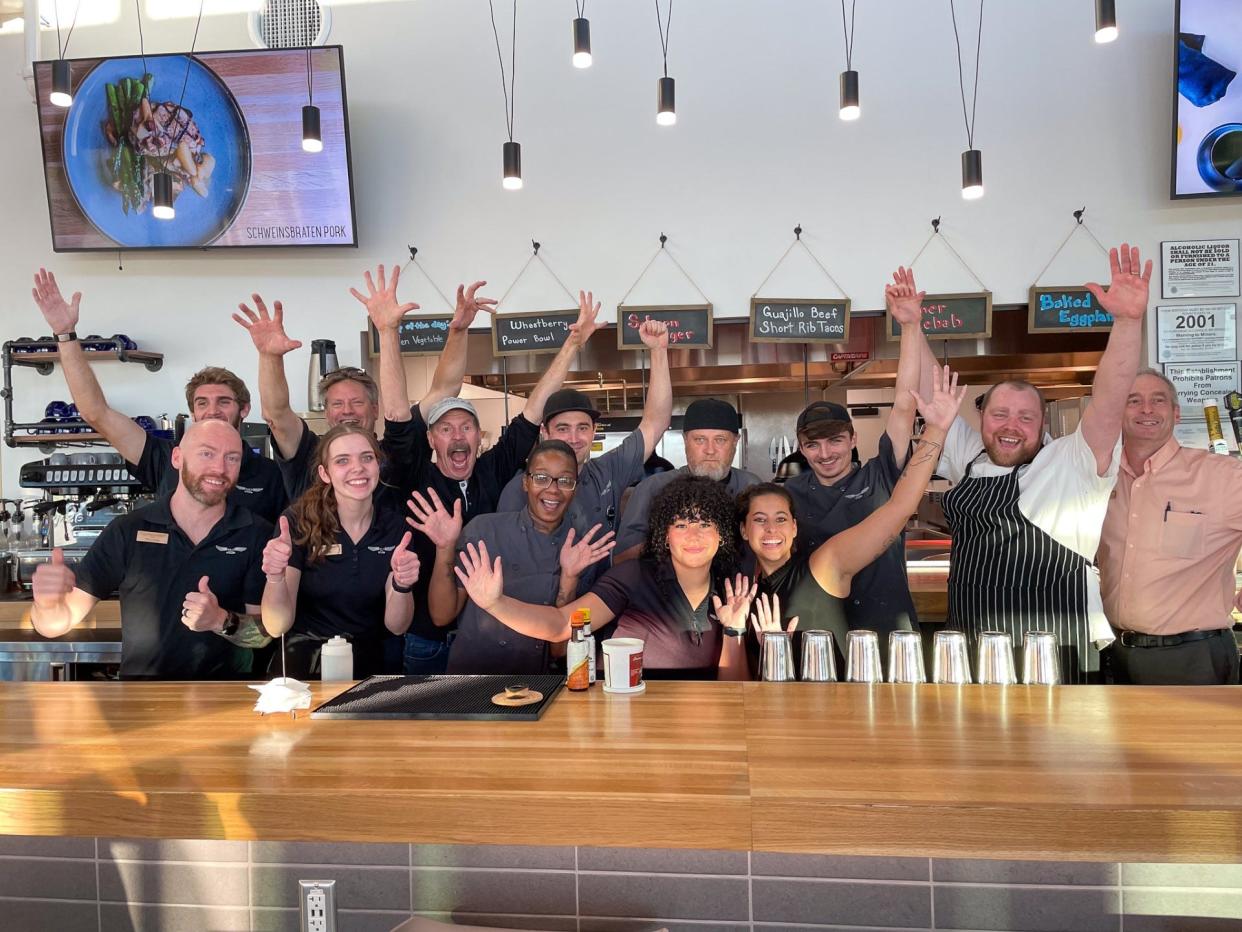 "Under the Radar" hosts Tom Daldin and Jim Edelman celebrate with the staff of Waco Kitchen during a recent visit to Battle Creek.