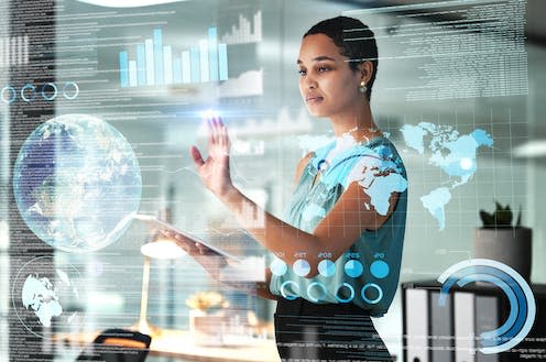 <span class="caption">AI systems are likely to find quick traction as assistants to humans.</span> <span class="attribution"><a class="link " href="https://www.shutterstock.com/image-photo/world-tablet-overlay-business-black-woman-2264932239" rel="nofollow noopener" target="_blank" data-ylk="slk:PeopleImages.com - Yuri A / Shutterstock;elm:context_link;itc:0;sec:content-canvas">PeopleImages.com - Yuri A / Shutterstock</a></span>