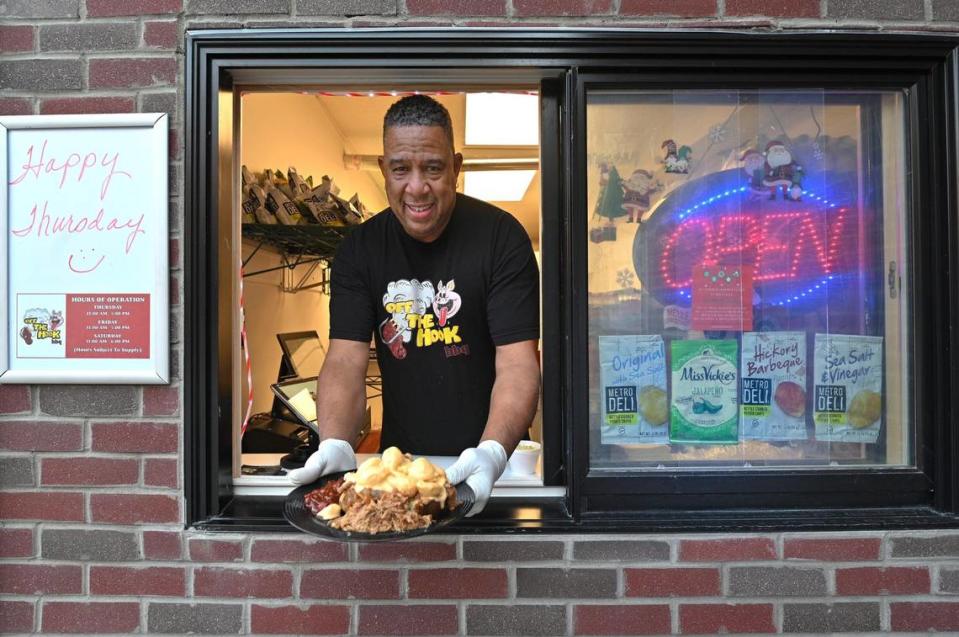 Owner Wardell Hooks serves barbecue from a to-go window at Off the Hook BBQ in Parkville.