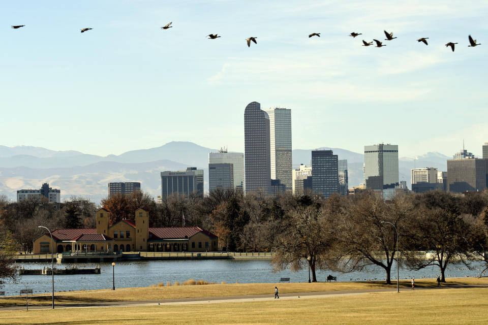 The Denver skyline is seen on Friday, Dec. 3, 2021. The Mile High City has already shattered its 87-year-old record for the latest measurable snowfall set on Nov. 21, 1934, and it's a little more than a week away from breaking an 1887 record of 235 consecutive days without snow. The scenario is playing out across much of the Rocky Mountains, as far north as Montana and in the broader Western United States, which is experiencing a megadrought that studies link to human-caused climate change. (AP Photo/Thomas Peipert)