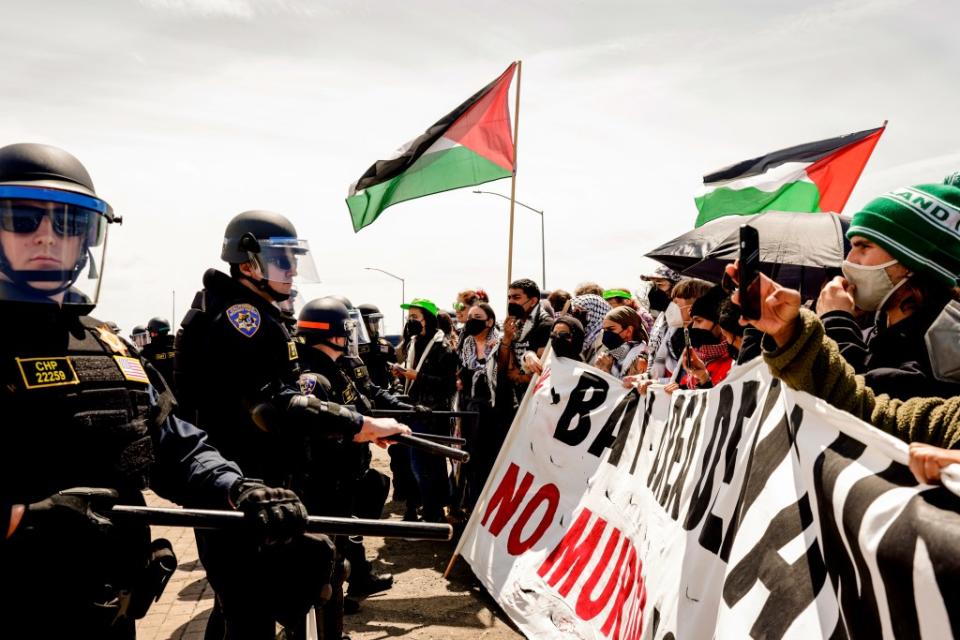 Demonstrators clashing with police in Oakland on I-880. Brontë Wittpenn/San Francisco Chronicle via AP