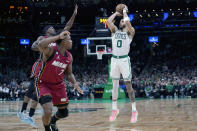 Boston Celtics forward Jayson Tatum (0) shoots against Miami Heat forward Jimmy Butler, back left, and guard Kyle Lowry (7) during the second half of Game 2 of the NBA basketball playoffs Eastern Conference finals in Boston, Friday, May 19, 2023. (AP Photo/Charles Krupa)