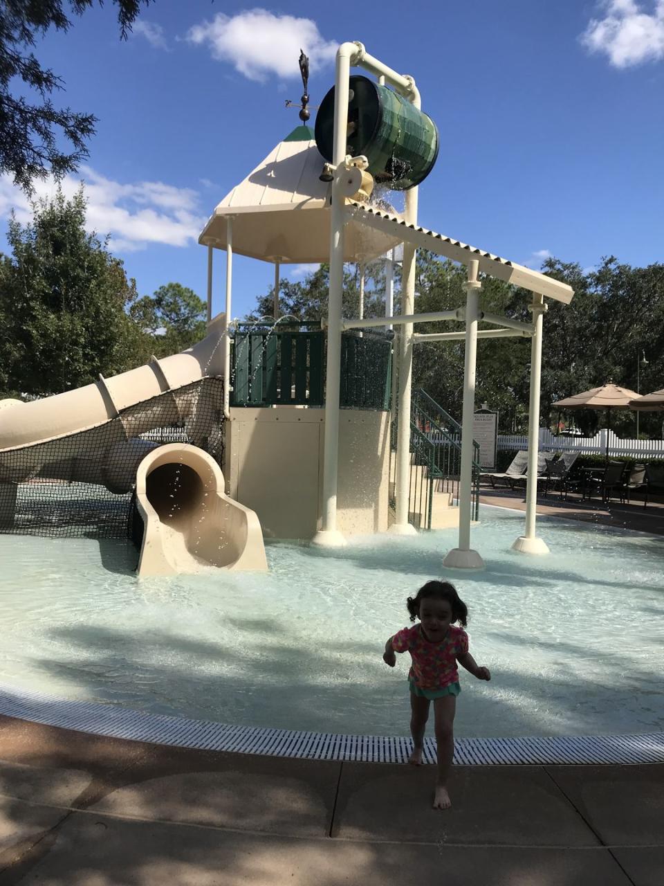 kids splash pad area with slide at disney saratoga springs