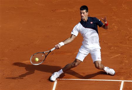 Novak Djokovic of Serbia returns the ball to Albert Montanes of Spain during the Monte Carlo Masters in Monaco April 15, 2014. REUTERS/Eric Gaillard