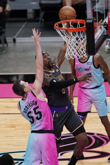 Lakers guard Kentavious Caldwell-Pope drives to the basket against Heat guard Duncan Robinson on Thursday in Miami.