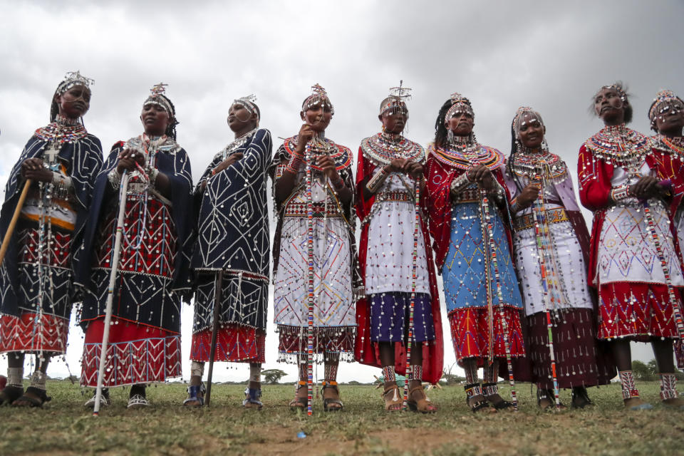 Maasai women spectators watch the Maasai Olympics in Kimana Sanctuary, southern Kenya Saturday, Dec. 10, 2022. The sports event, first held in 2012, consists of six track-and-field events based on traditional warrior skills and was created as an alternative to lion-killing as a rite of passage. (AP Photo/Brian Inganga)