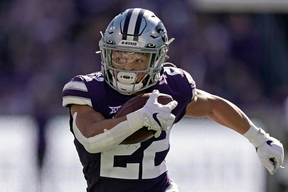 Kansas State running back Deuce Vaughn runs the ball during the first half of an NCAA college football game against TCU, Saturday, Oct. 30, 2021, in Manhattan, Kan. The Big 12 will begin its 27th season this week with some uncertainty of what will stand out offensively since there are three new head coaches and plenty of different skill players.