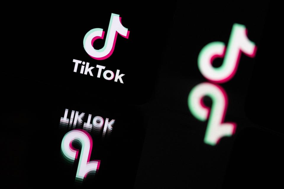 This photograph taken in Mulhouse, eastern France on October 19, 2023, shows the logo of the social media video sharing app Tik Tok reflected in mirrors.