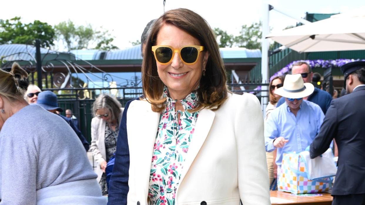  Carole Middleton wears a floral maxi dress with a cream blazer at Day 4 of Wimbledon 2024 . 