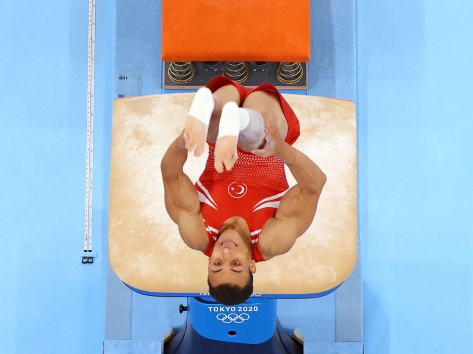 Adem Asil of Team Turkey flips over the vault in an overhead shot at the Tokyo Olympics