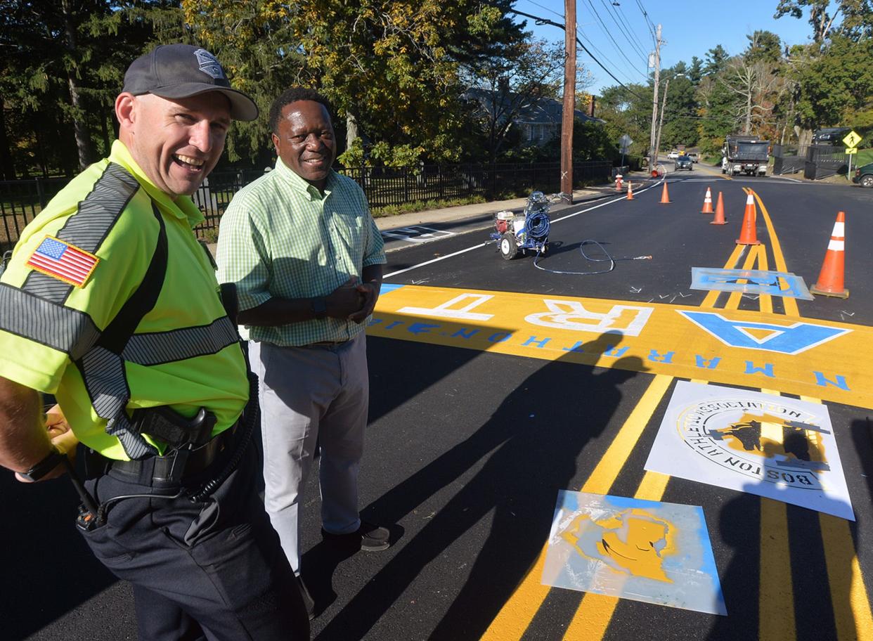 Hopkinton Town Manager Norman Khumalo, right, and Hopkinton police officer Kevin Sager were present for the official painting of the start line in advance of the 125th running of the Boston Marathon in October 2021.