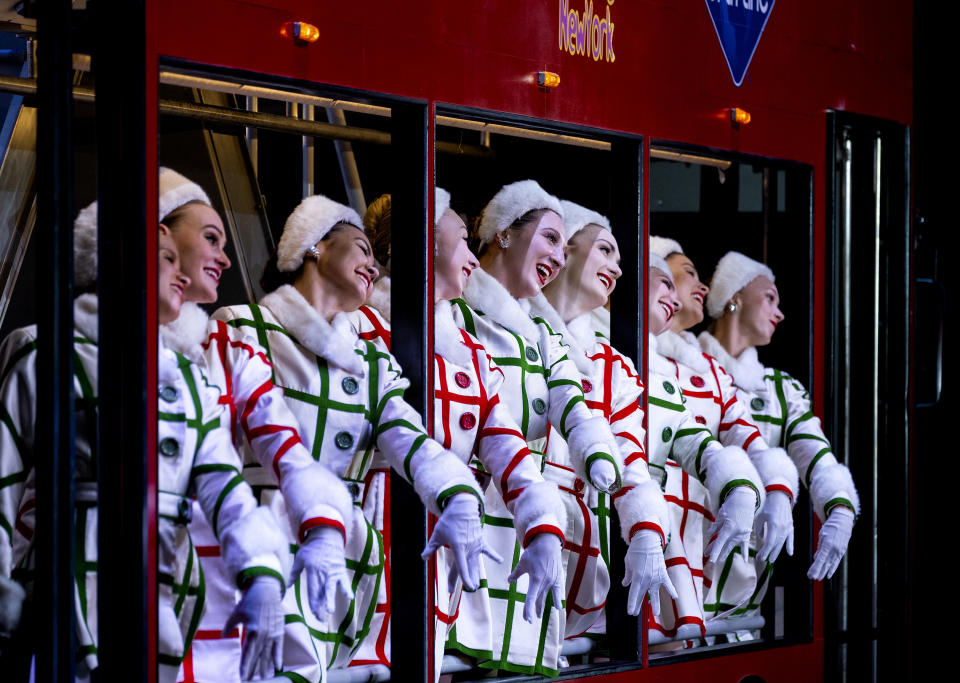 In this Monday, Nov. 25, 2019 photo, Rockette Sydney Mesher, fifth from right, rides a depiction of a sightseeing bus during a performance of "New York at Christmas," part of the Christmas Spectacular at Radio City Music Hall in New York. Mesher, who was born without a left hand due to the rare congenital condition symbrachydactyly, is the first person with a visible disability ever hired by New York's famed Radio City Rockettes. (AP Photo/Craig Ruttle)