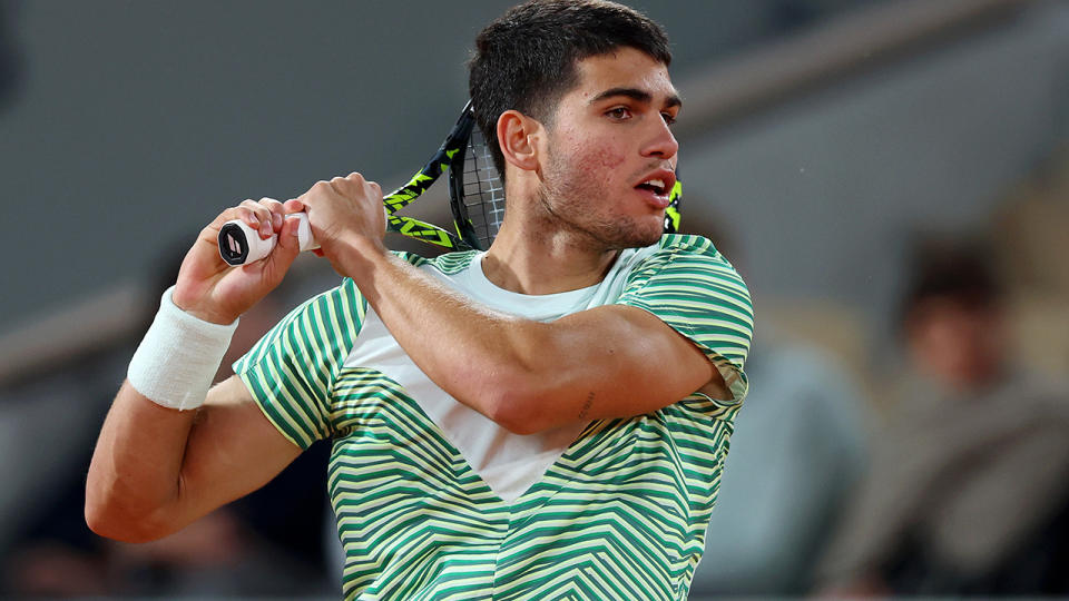 Carlos Alcaraz plays a backhand shot at the French Open.