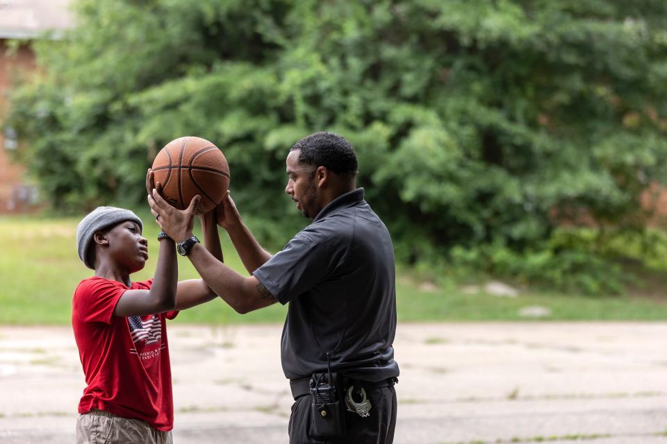 Lt. Blake Gable from the Clarke County Sheriff’s Office helps Robert Blackwell, 12, with his form at the Nellie B Community Center during the opening week of the Boys & Girls Club’s satellite campus on Friday, July 1, 2022 in Athens.