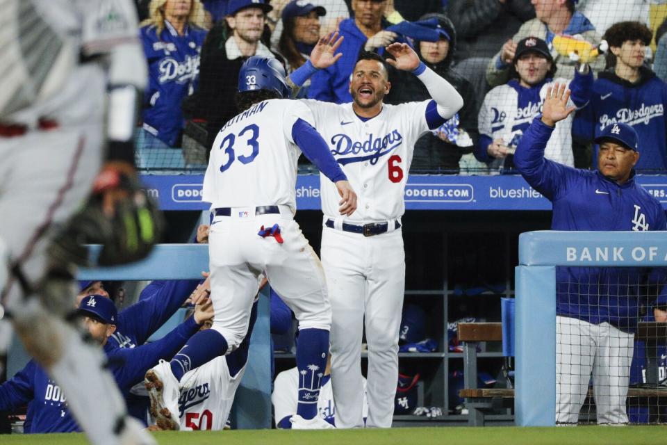 James Outman is congratulated by David Peralta (6) after scoring a run.