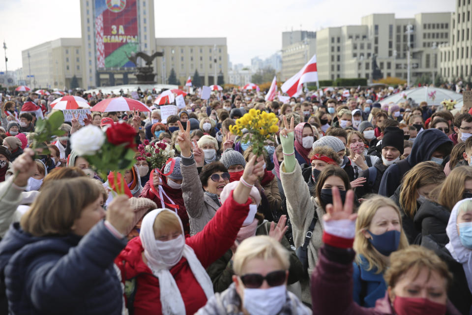 People, most of them pensioners, hold old Belarusian national flags march during an opposition rally to protest the official presidential election results in Minsk, Belarus, Monday, Oct. 26, 2020. Factory workers, students and business owners in Belarus have started a general strike, calling for authoritarian President Alexander Lukashenko to resign after more than two months of mass protests triggered by a disputed election. (AP Photo)