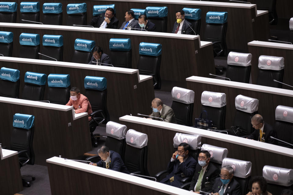 Members of the House, left and Senate, right attend a joint-session at the Parliament in Bangkok, Thailand, Wednesday, Nov. 18, 2020. Violent confrontations took place Tuesday outside Parliament between police and pro-democracy protesters who backed a motion to make substantive changes to the constitution. (AP Photo/Sakchai Lalit)