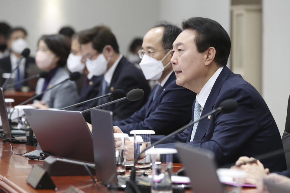 South Korean President Yoon Suk Yeol, right, speaks during a cabinet meeting at the presidential office in Seoul, South Korea, Tuesday, Nov. 29, 2022. South Korea’s government issued an order Tuesday for some of the thousands of striking truck drivers to return to work, insisting that their nationwide walkout over freight fare issues is hurting an already weak economy. (Ahn Jung-hwan/Yonhap via AP)